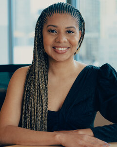 Jacqueline V. Twillie, seated at a desk.